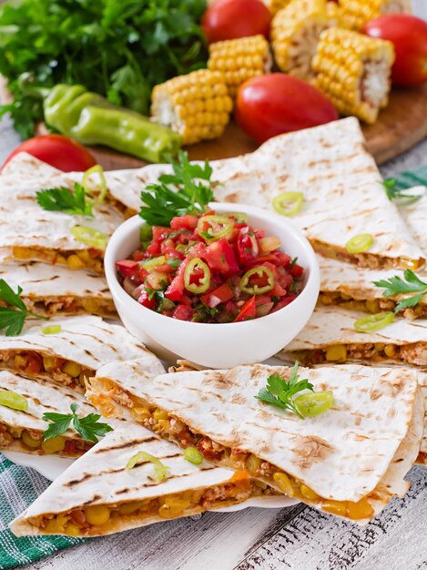 Mexican Quesadilla wrap with chicken, corn and sweet pepper and salsa
