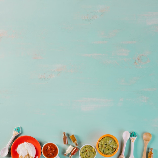 Mexican sauces on blue background