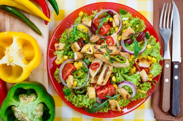 Mexican spicy chicken salad on a plate. Grilled chicken meat with a tasty selection of vegetables