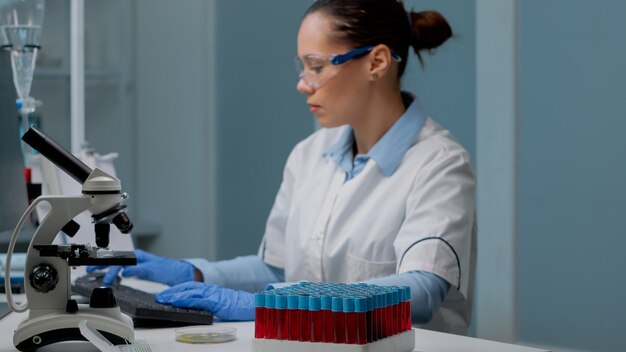 Microbiology specialist using computer in laboratory