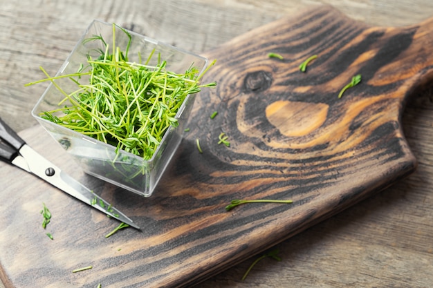 Microgreens. Lentil sprouts on a wooden background.