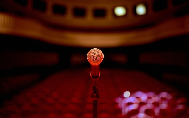 Microphone in the center in front of an empty concert hall before the standup performance . high quality photo