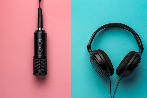 Microphone and headphones on pink and blue background