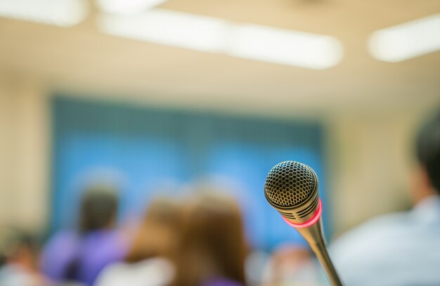 Microphone with unfocused background audience