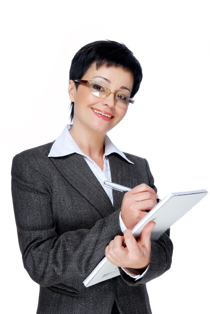 Mid adult businesswoman in grey business suit working