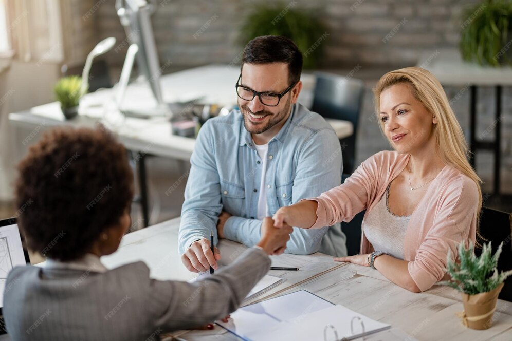 An agent shaking hands with their client