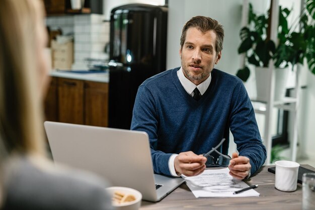 Mid adult insurance agent talking with a client about potential financial investments