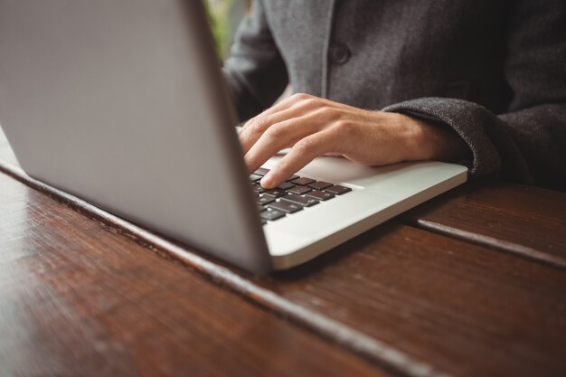 Mid section of man using laptop