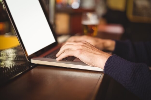 Mid section of man using laptop