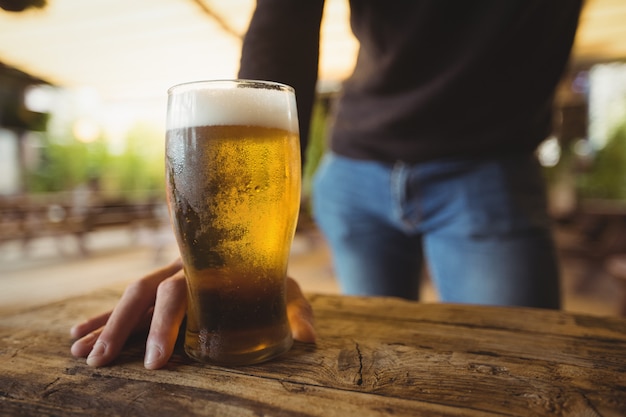 Mid section of man with glass of beer