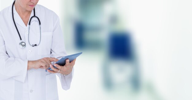 Средняя часть женщины-врача с помощью цифрового планшета в больнице