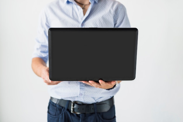 Mid section view of a businessman using laptop