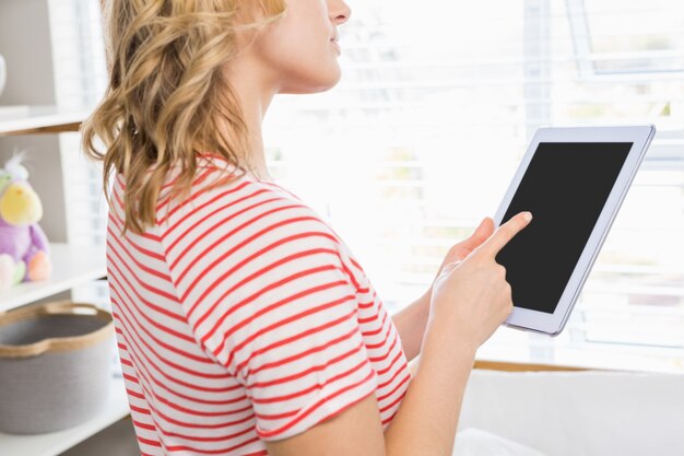 Free photo mid-section of woman using digital tablet