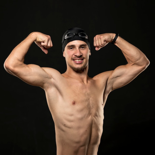 Mid shot athlete flexing muscles