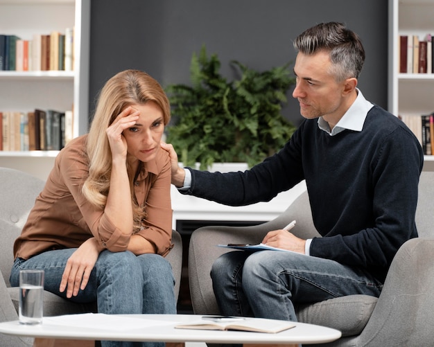 Free photo mid shot counselor comforting patient