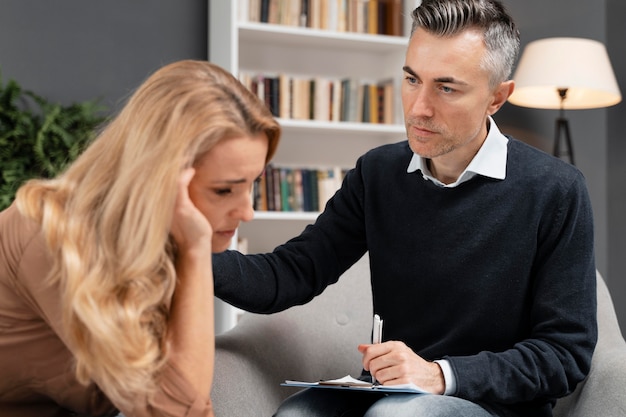 Mid shot counselor comforting woman