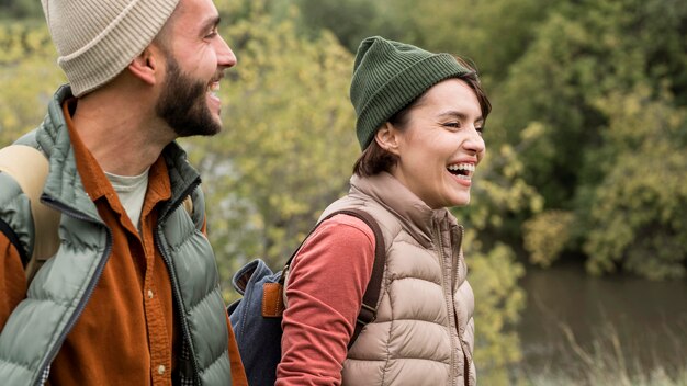 Mid shot couple laughing in nature