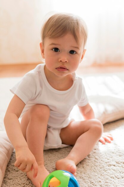 Mid shot cute baby and toy