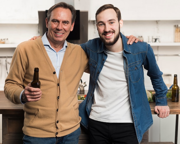 Mid shot father and son posing in kitchen