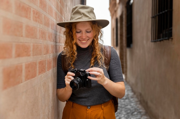 Mid shot girl with hat looking at camera