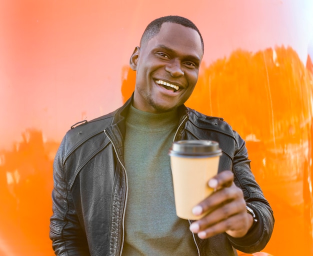 Mid shot happy man holding coffee standing by food truck