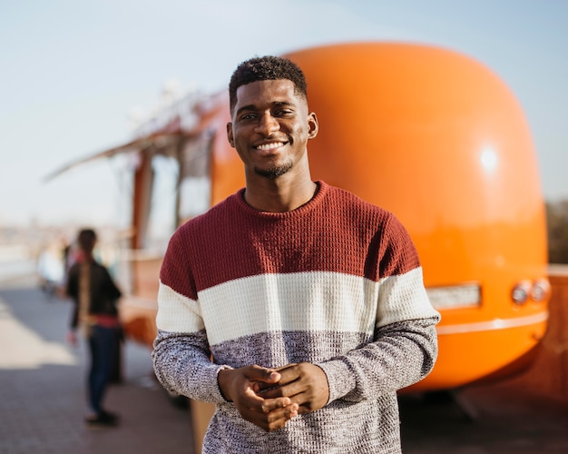 Mid shot man in front of food truck