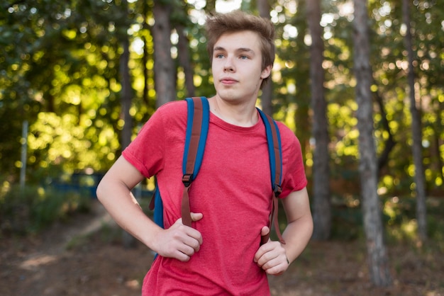 Free photo mid shot man with backpack in forest