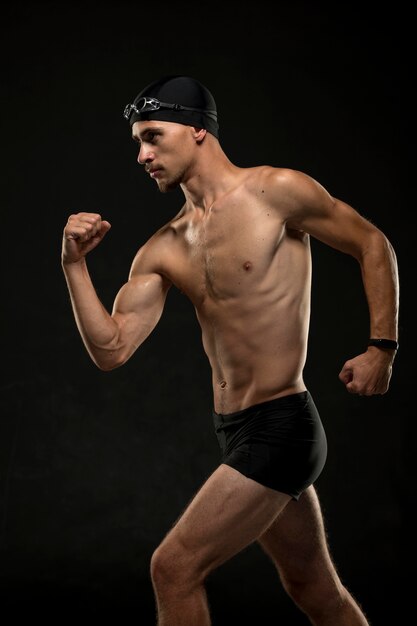 Mid shot swimmer flexing muscles
