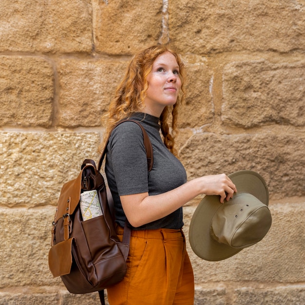 Free photo mid shot woman holding hat