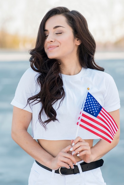 Mid shot woman holding usa flag