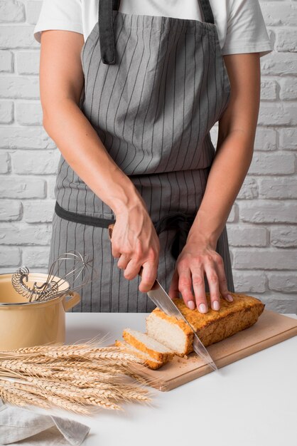 Mid shot woman slicing banana bread