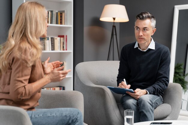 Mid shot woman talking to man therapist