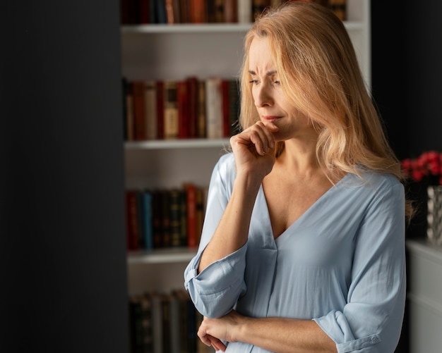 Mid shot worried woman therapist in office