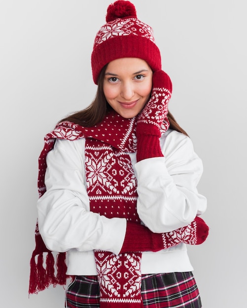 Mid shot young woman with hat and mittens