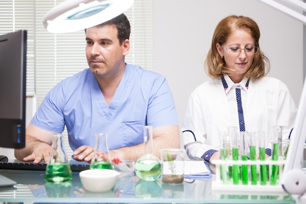 Free photo middle age female scientist working with her assistant in a factory laborator.