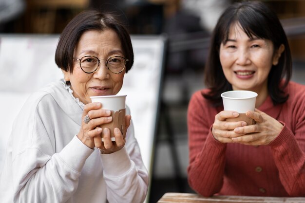 Middle age friends having fun at coffee shop