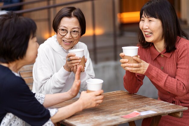 Middle age friends having fun at coffee shop