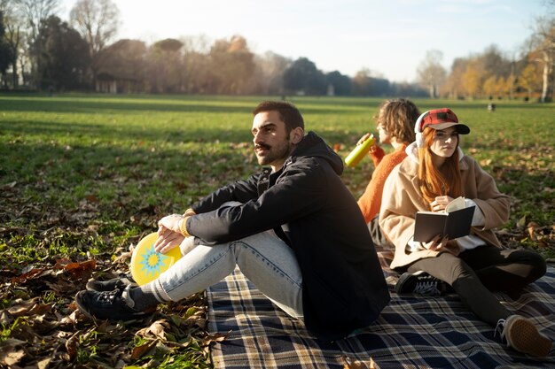 Middle age friends having fun together at picnic