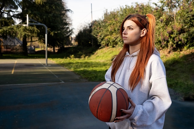 Middle age friends having fun together playing basketball