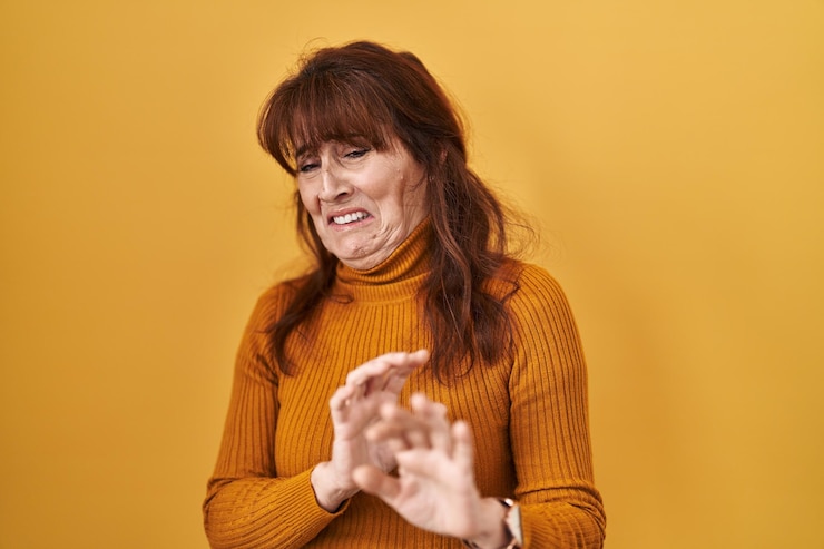 Free Photo middle age hispanic woman standing over yellow background disgusted expression displeased and fearful doing disgust face because aversion reaction