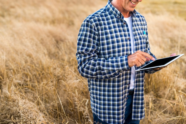 Middle age man holding a tablet