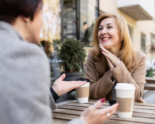 Middle aged best friends spending time together outside