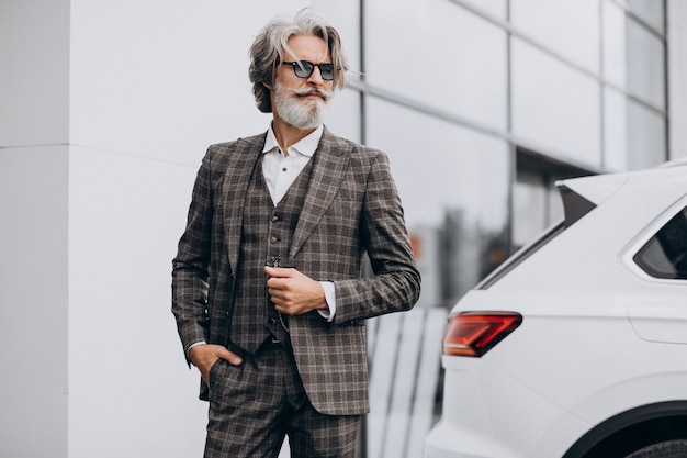 Free photo middle aged business man in a car salon