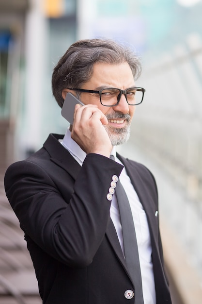 Middle-aged business man talking on smartphone