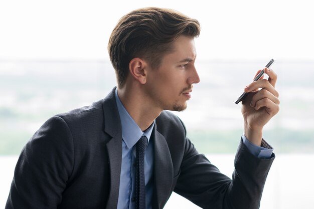 Middle-aged Businessman Looking at Smartphone