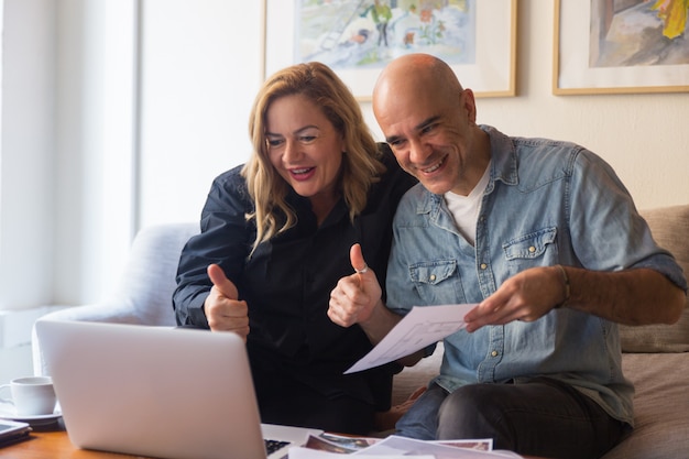 Middle aged couple showing thumb up