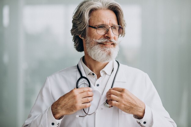 Middle aged handsome doctor in a hospital