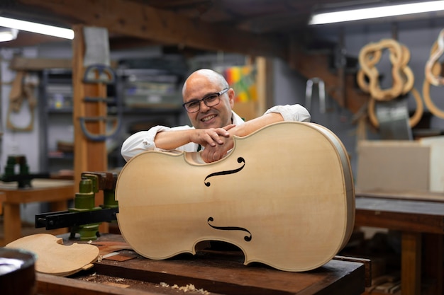 Middle aged man in his instrument workshop