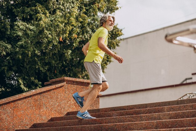 Middle aged man jogging down and upstairs