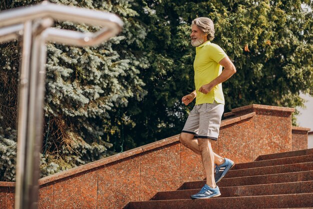 Middle aged man jogging down and upstairs